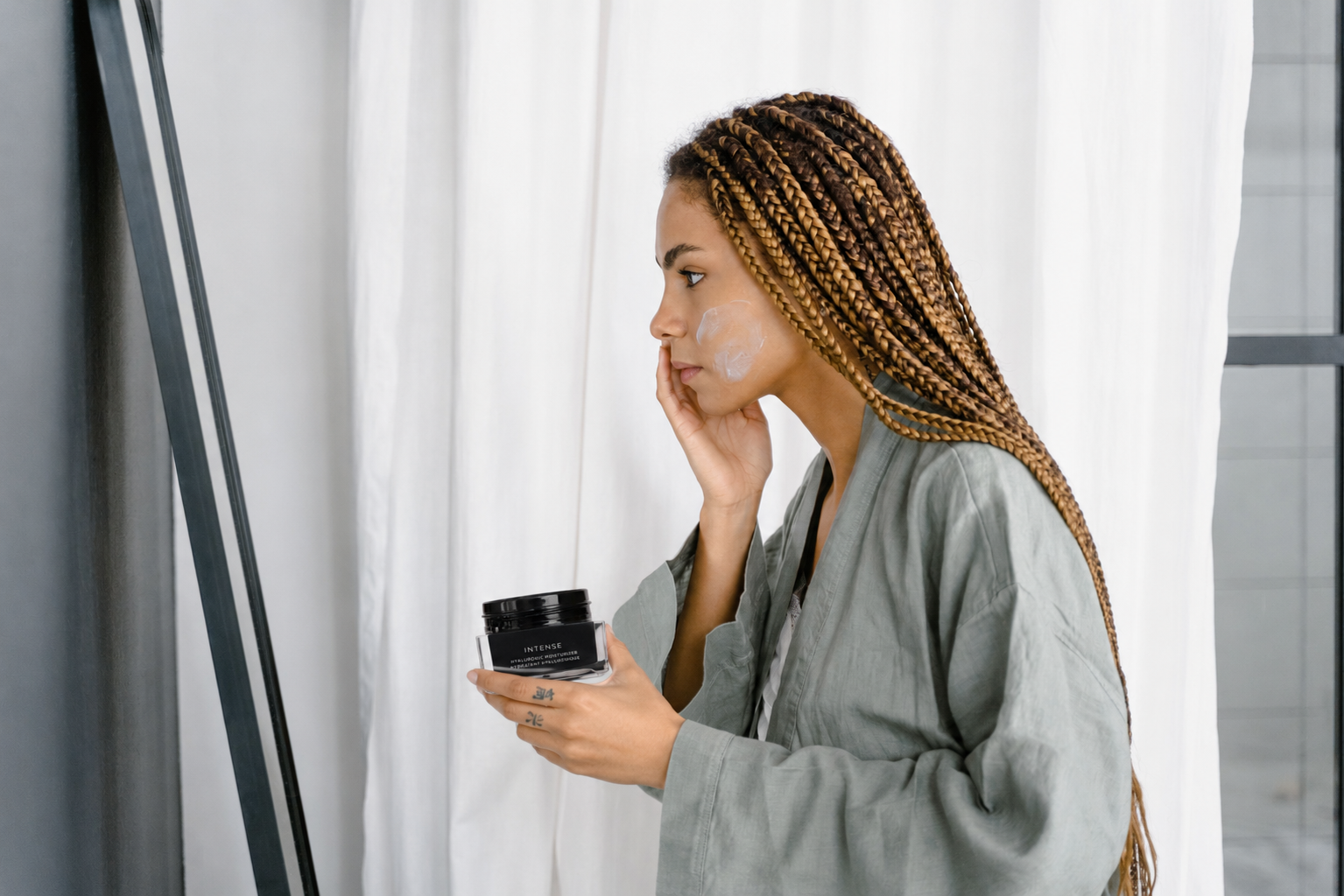 Woman applying HydraLuxa hyaluronic acid moisturizer